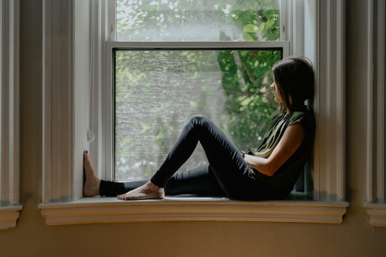 A woman resting on a window seat