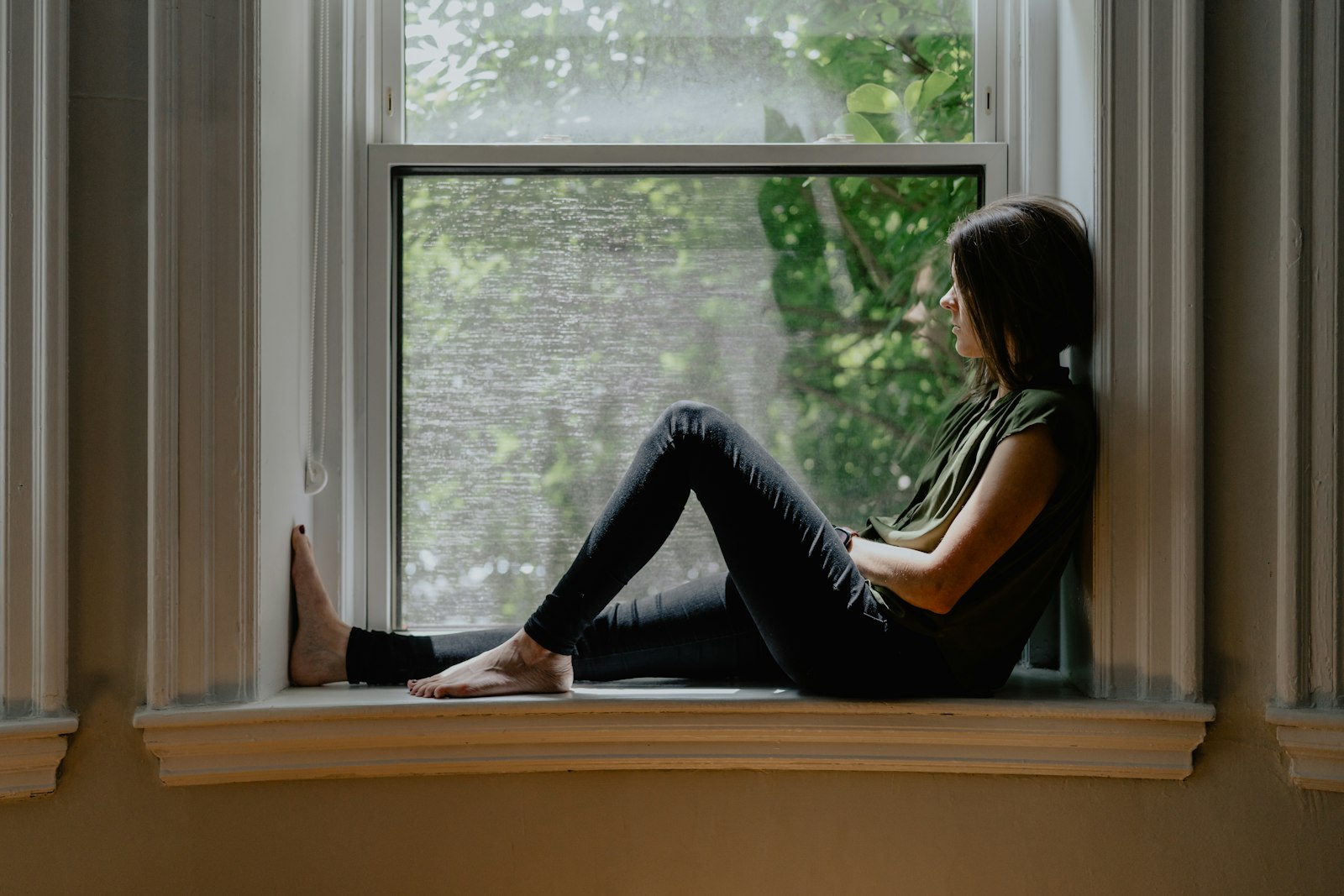 A woman resting on a window seat