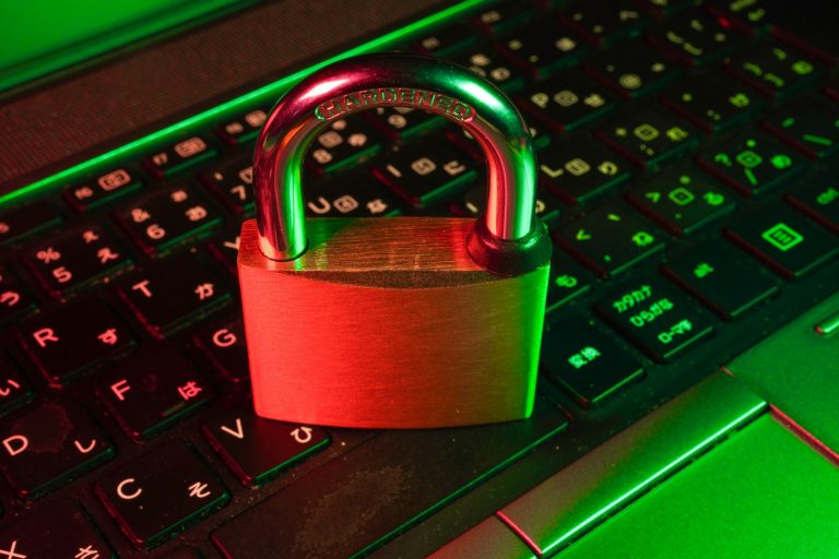 A red padlock on a backlit keyboard